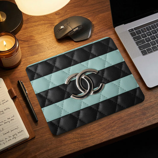 Quilted mouse pad with Chanel logo and horizontal stripes.