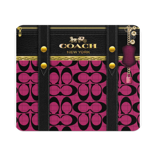 Coach pattern mousepad with black leather accents and gold hardware.