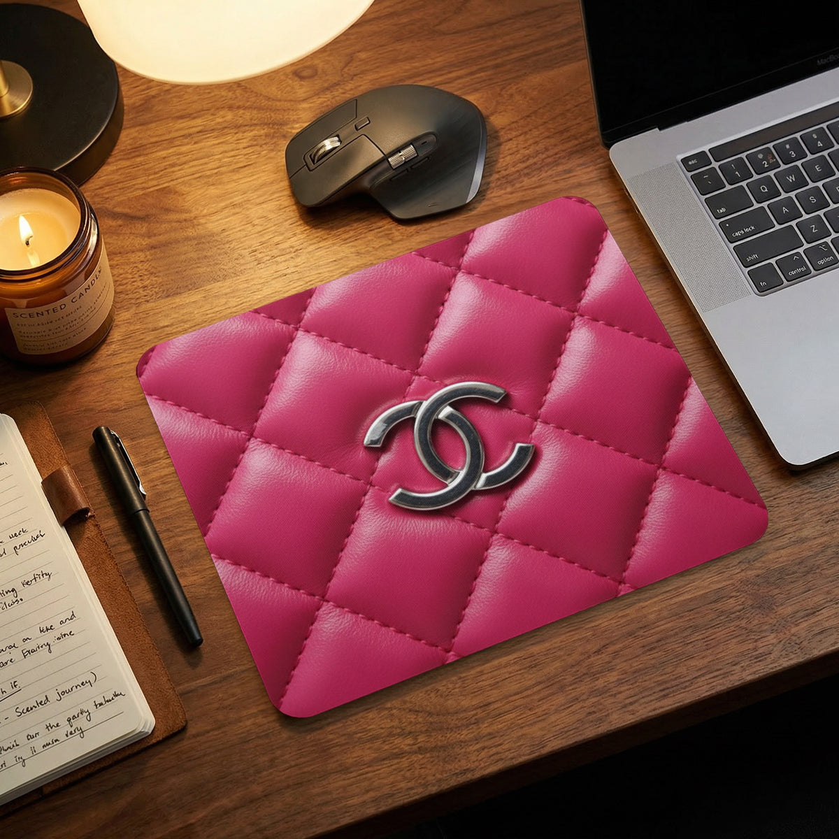 Quilted pink mousepad with silver interlocking Cs logo.