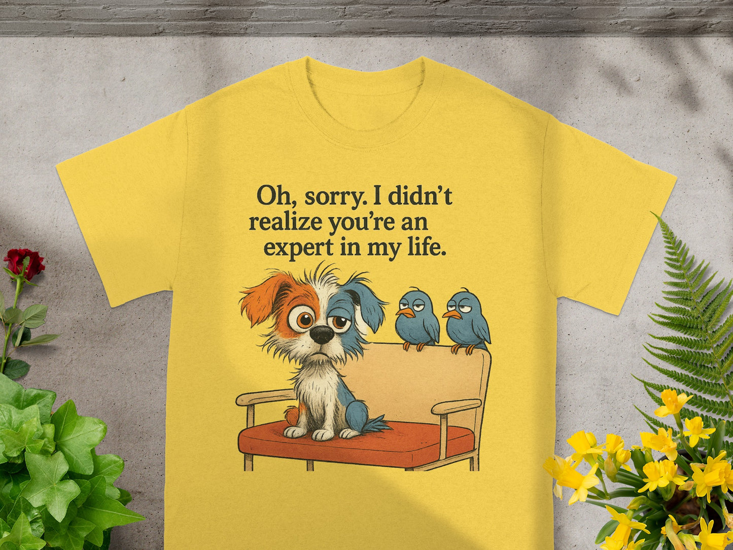 Yellow t-shirt with cartoon dog and birds on a couch, text "Oh, sorry. I didn't realize you're an expert in my life."