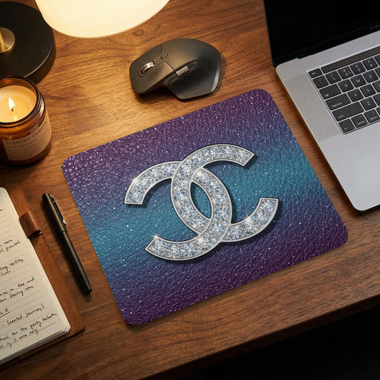 Mousepad with sparkly double C logo on gradient background.