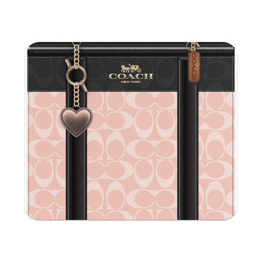 Coach New York logo on a pink and black patterned case with heart charm.
