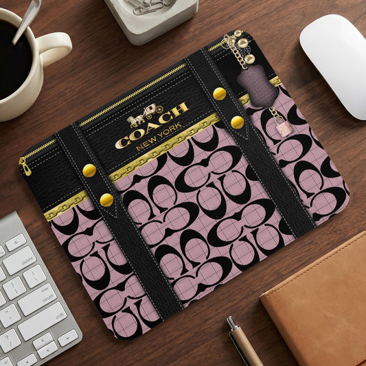 Coach mousepad with black leather accents and pink signature pattern.
