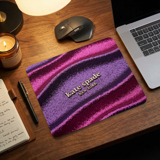 Kate Spade New York mousepad with glittery purple and pink stripes.