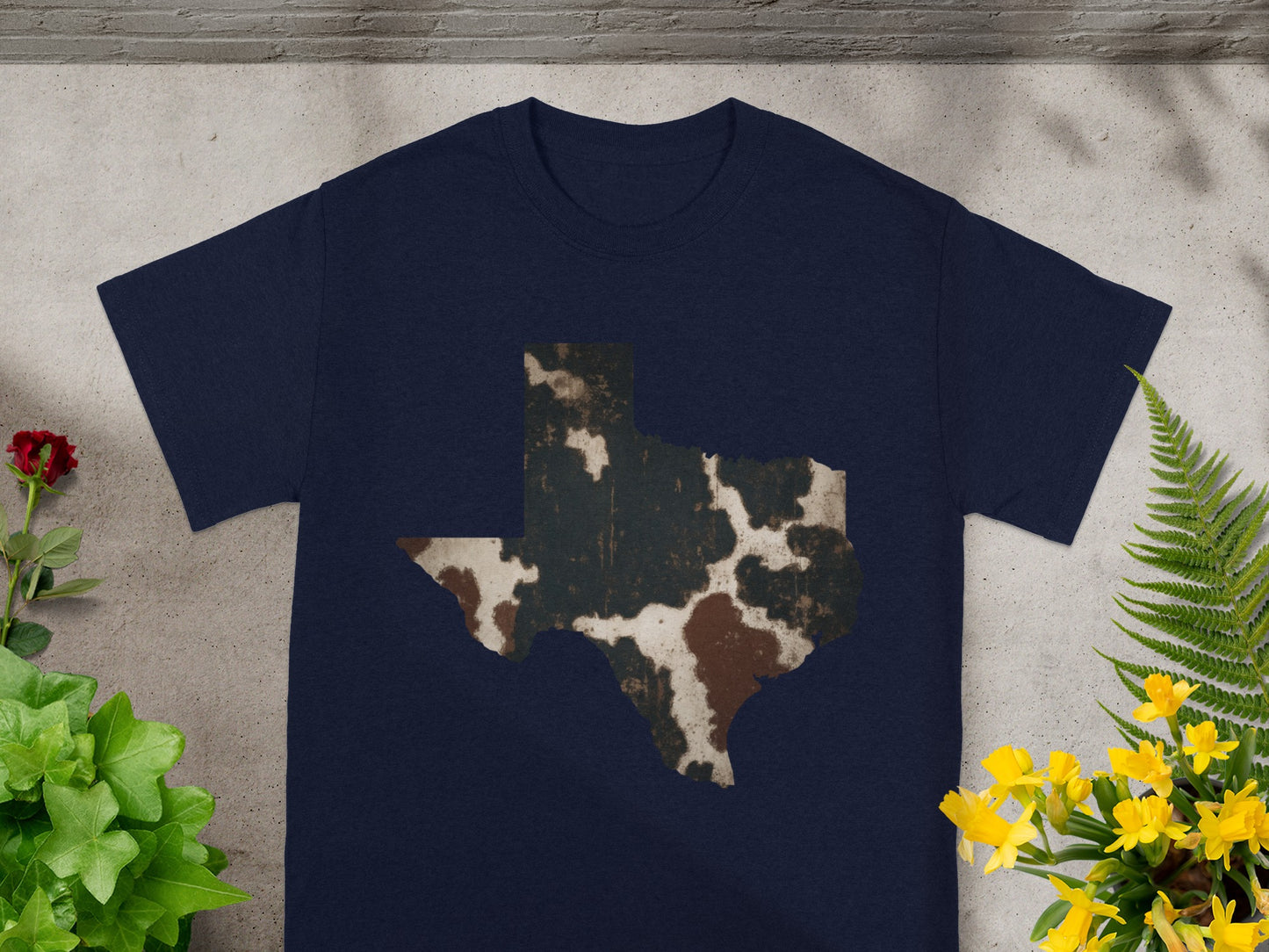 Navy t-shirt with a distressed Texas shape featuring cow print.