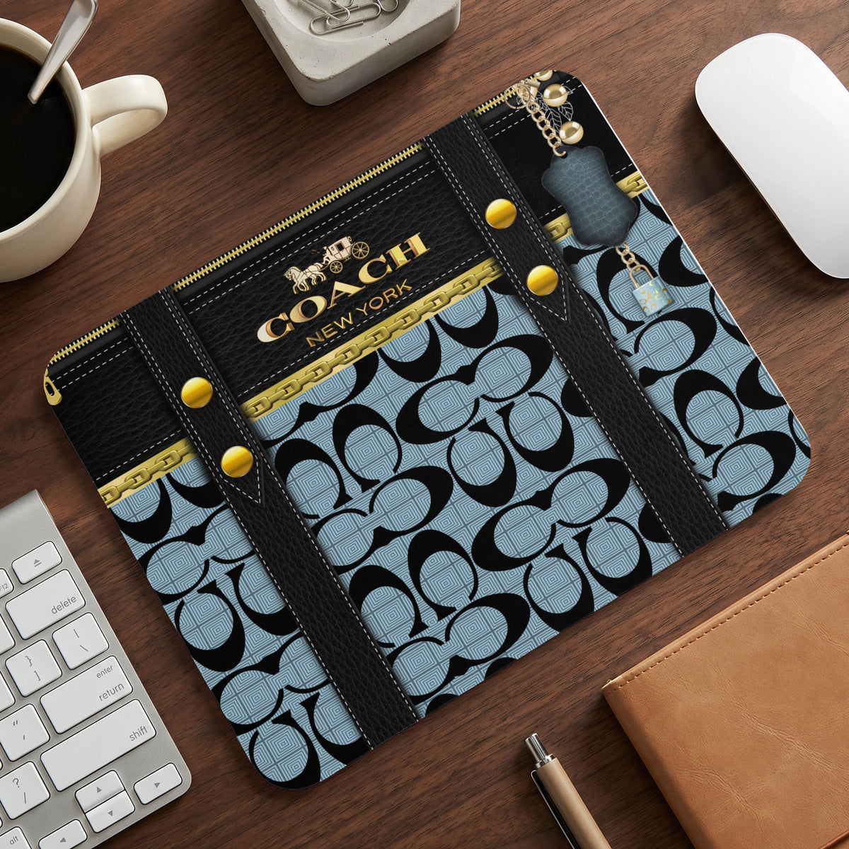Coach mousepad with signature "C" pattern, logo, and keychain detail.