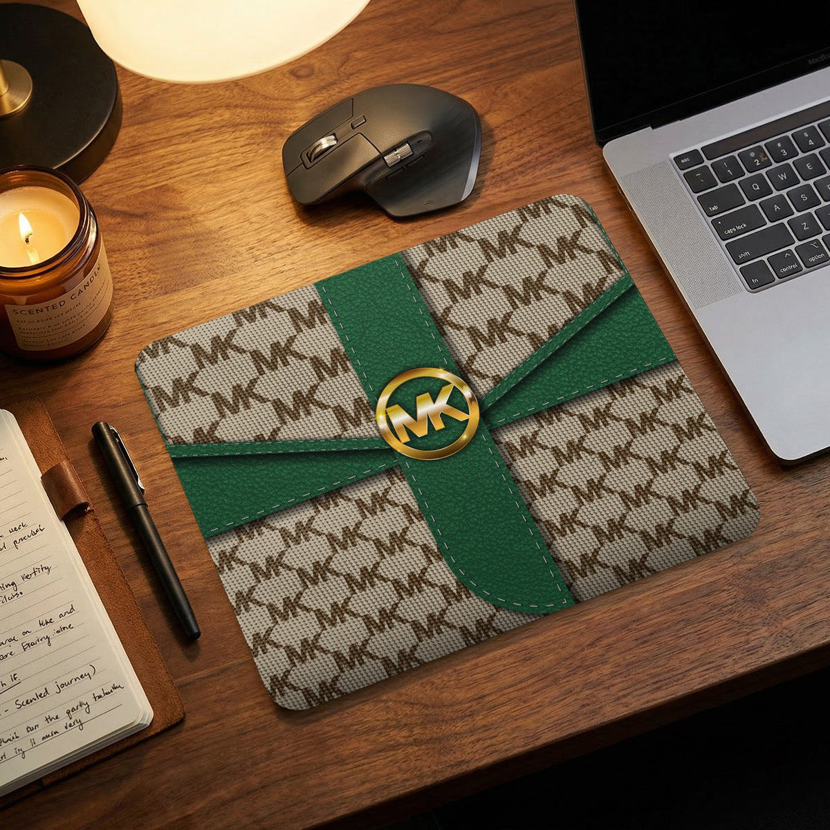 MK logo mousepad with tan monogram pattern and green ribbon accents.