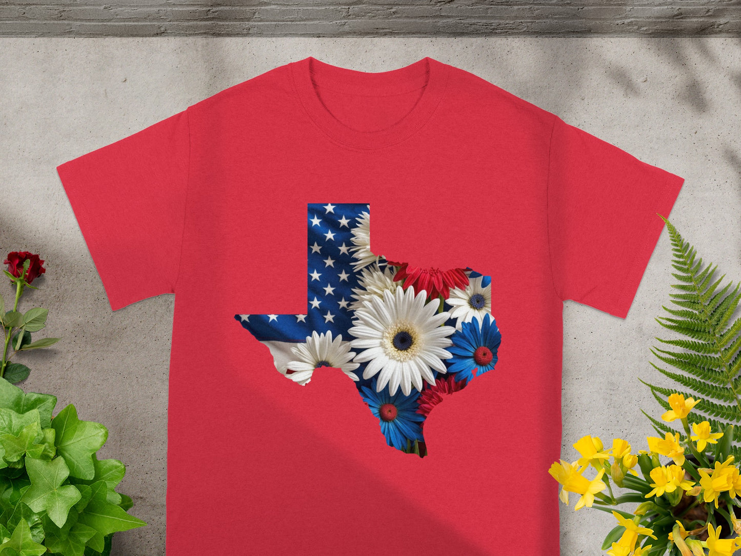 Red t-shirt with Texas outline filled with American flag and patriotic flowers.