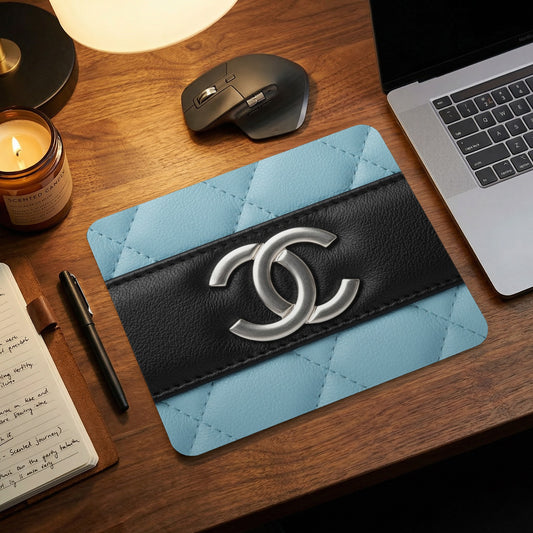 Quilted light blue mousepad with black band and silver double C logo.