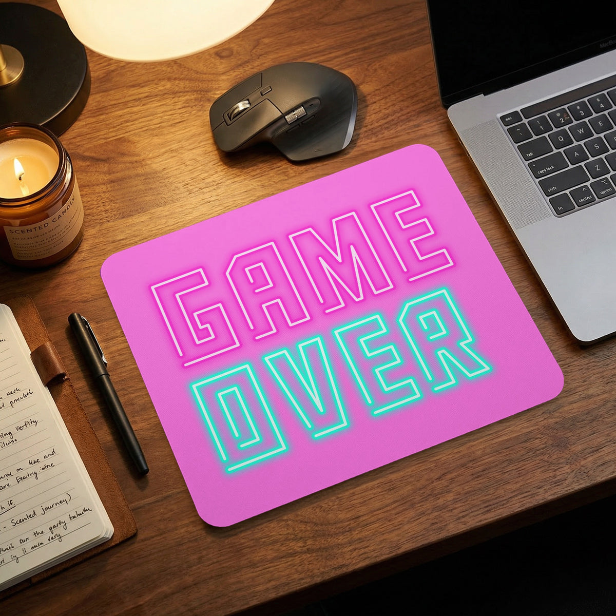 A pink mouse pad featuring the text GAME OVER in pink and turquoise.