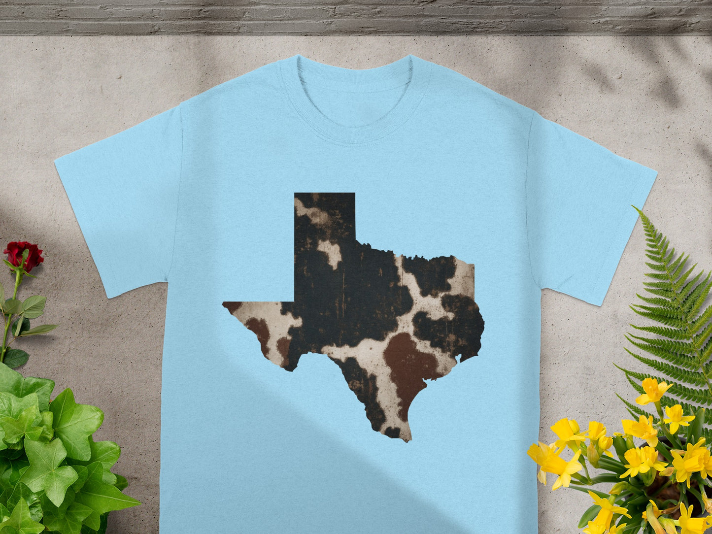 Light blue t-shirt with Texas map outline in cowhide pattern.