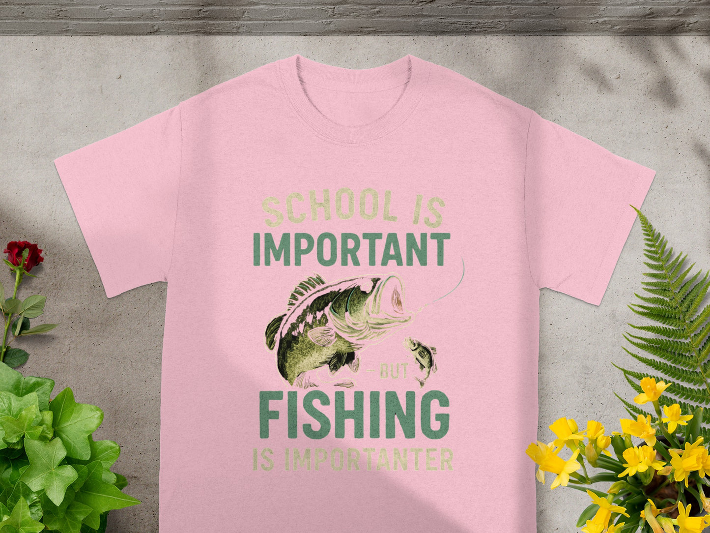 Pink t-shirt with "School is important but fishing is importanter" and fish graphic.