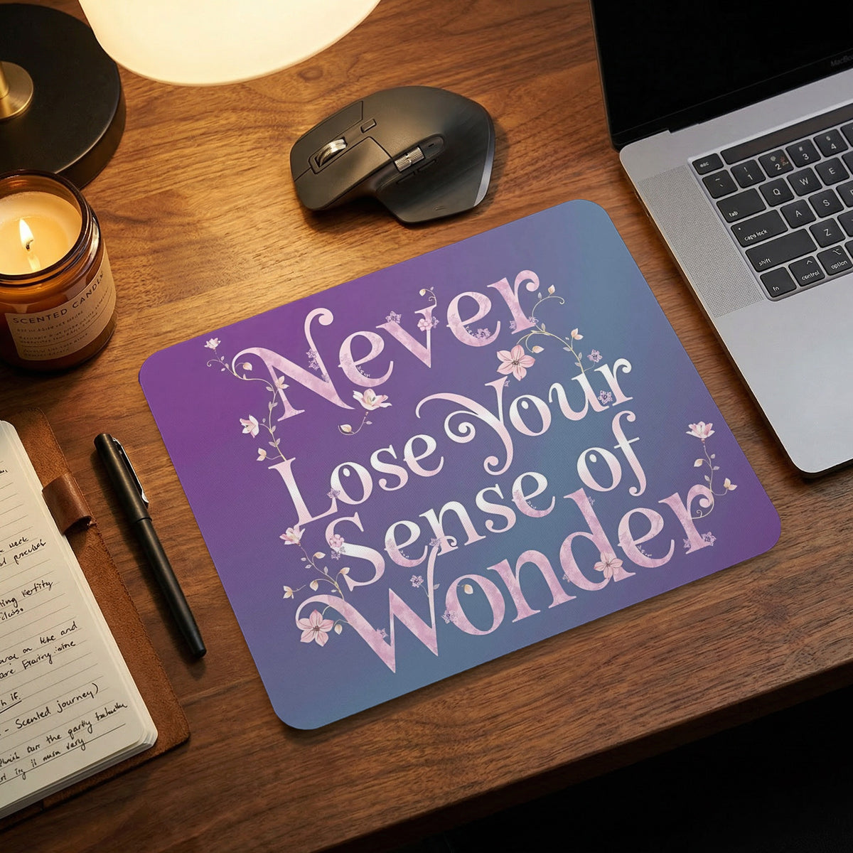 Mousepad with "Never Lose Your Sense of Wonder" quote and floral accents on purple gradient.