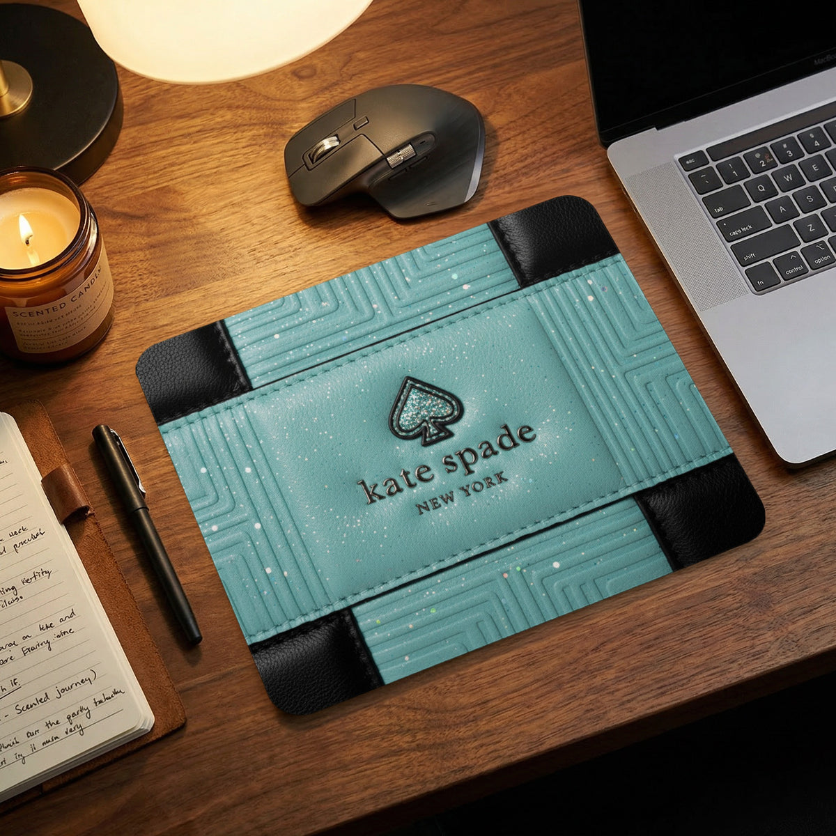 Kate Spade mousepad with glitter details and spade logo on a desk.