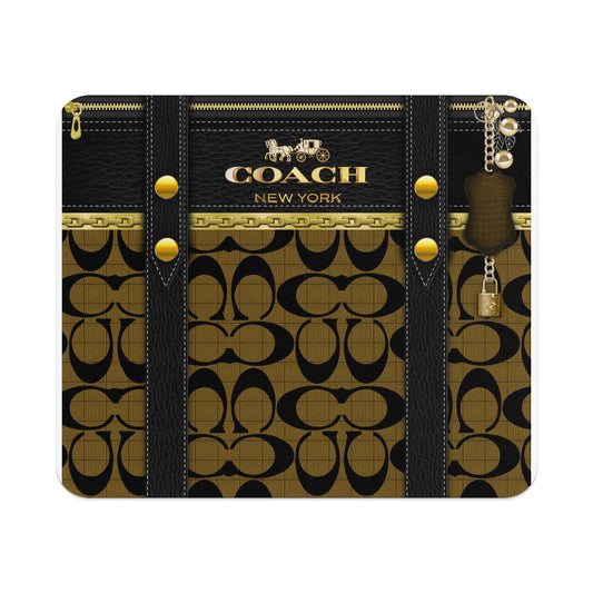 Coach New York logo with chain, padlock, and key charm on signature pattern.