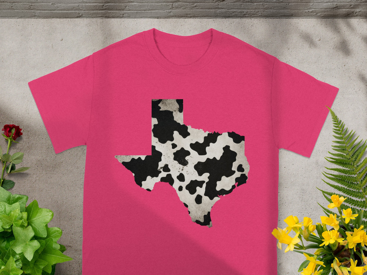 Pink t-shirt with Texas outline in black and white cow print.