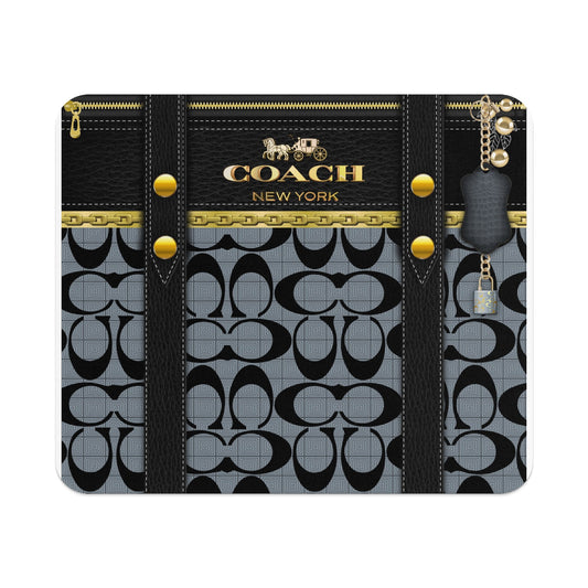 Coach pattern phone case with gold hardware and a padlock charm.