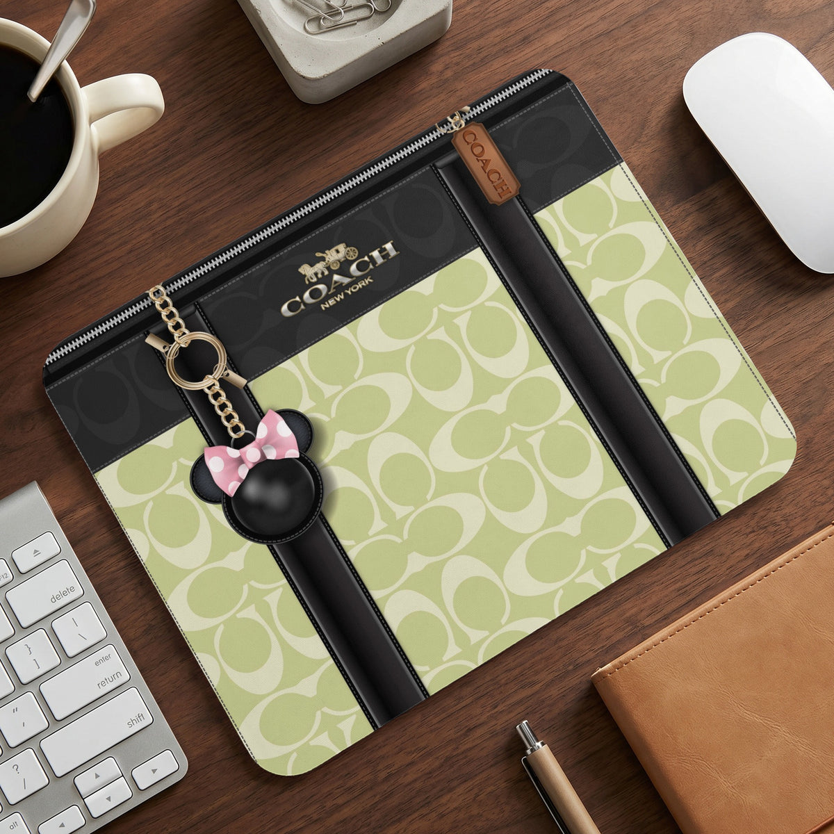 Coach monogram clutch with Minnie Mouse charm and keychain.