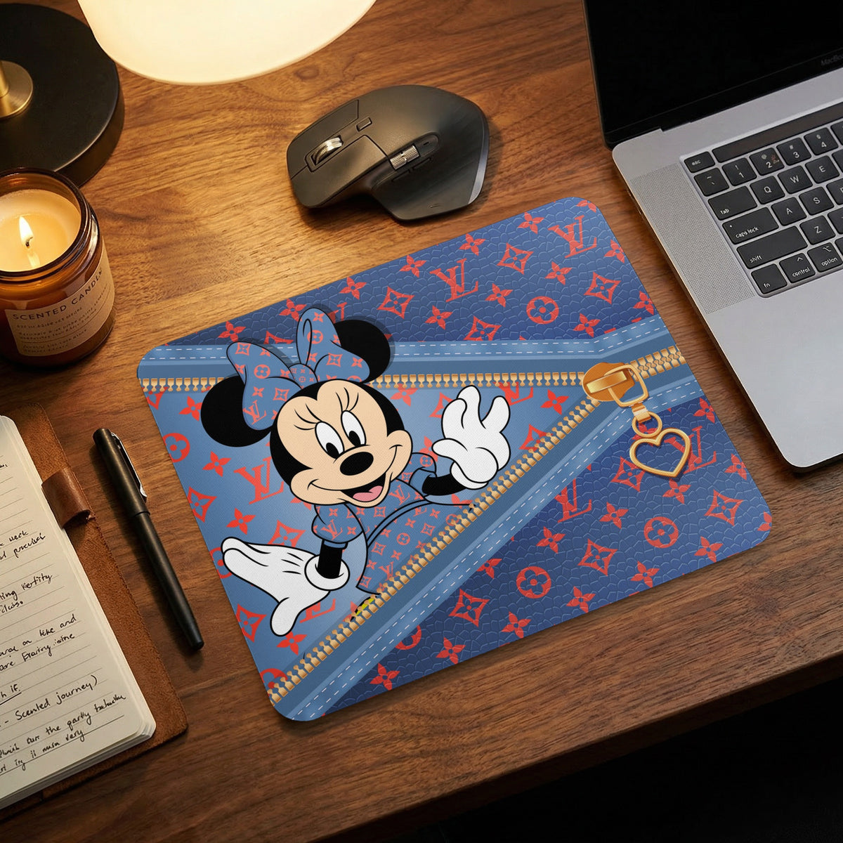 Minnie Mouse on a blue mousepad with a red monogram pattern and zipper detail.