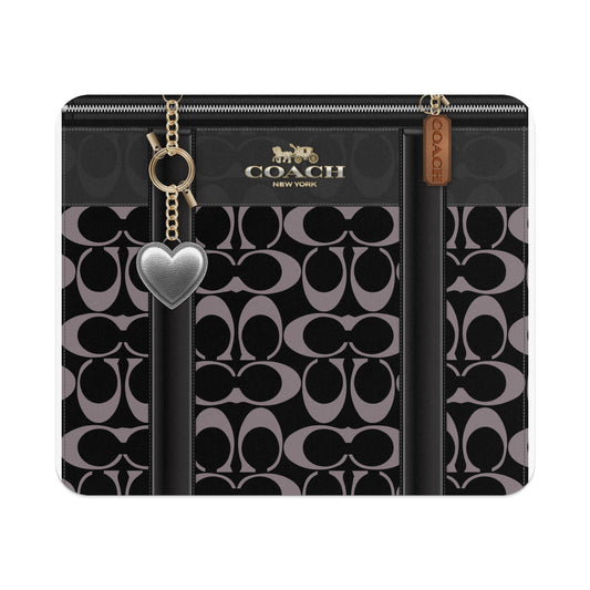 Coach pattern with logo, heart charm, and leather tag.
