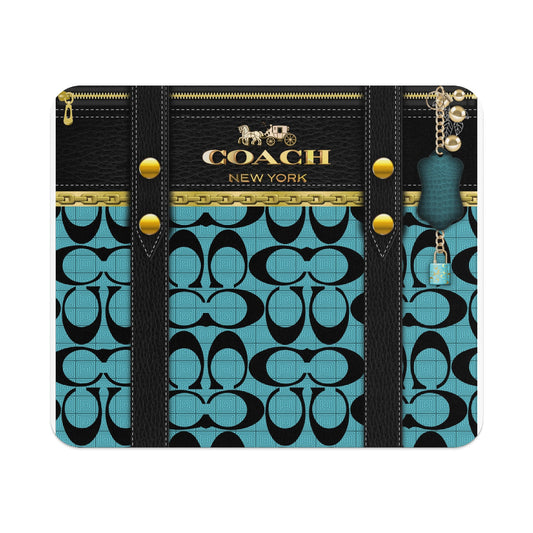 Coach pattern on teal with black leather accents and gold hardware.