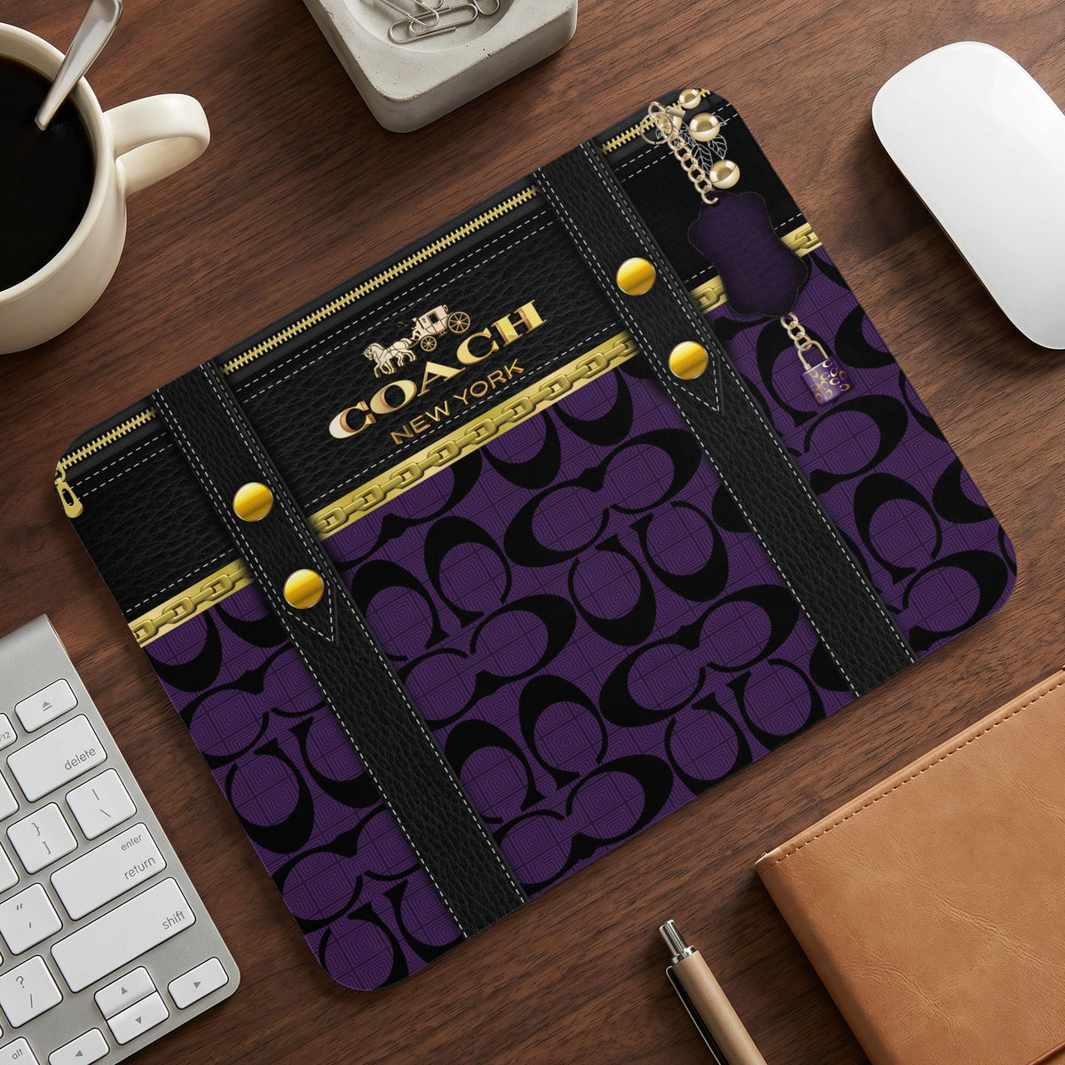 Coach New York mousepad with purple and black signature pattern and gold accents.