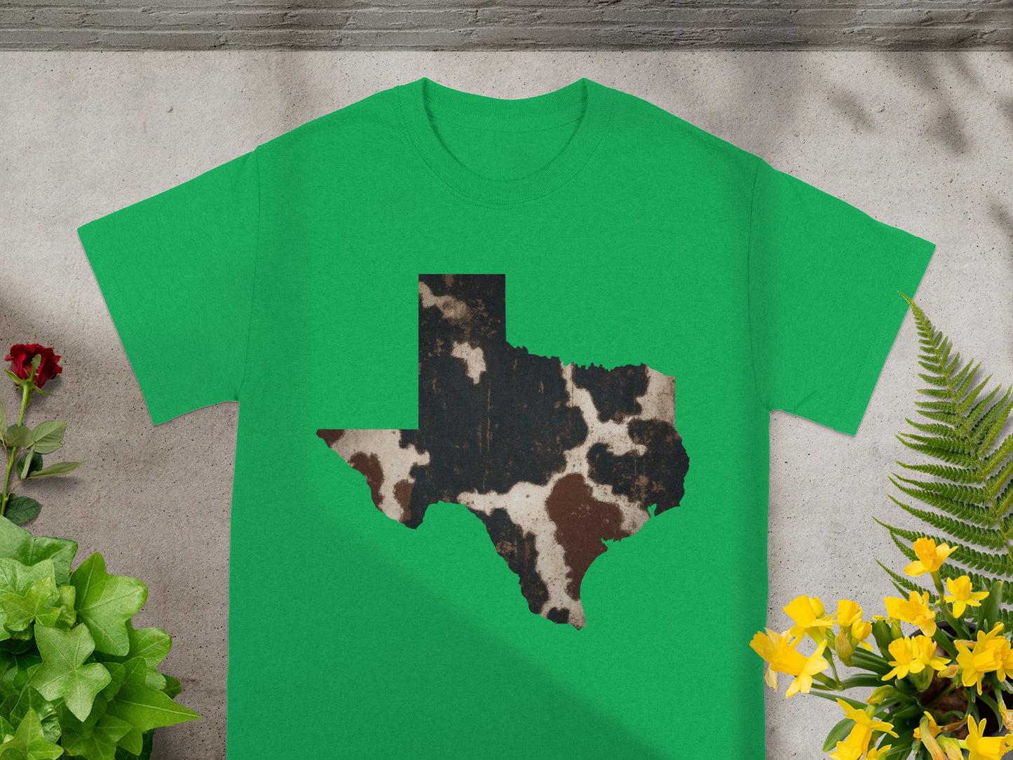 Green t-shirt with Texas outline featuring cow print detail.