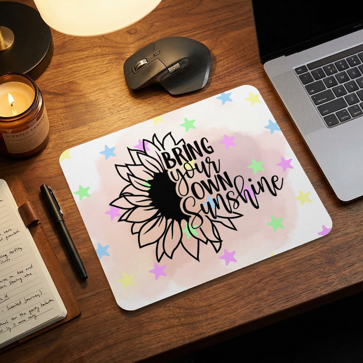 A rectangular mousepad featuring a black sunflower graphic with the text Bring Your Own Sunshine.