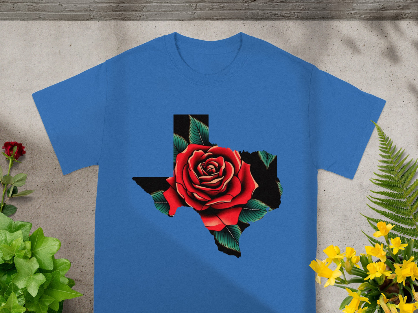 Blue t-shirt with a graphic of a red rose within the state of Texas outline.