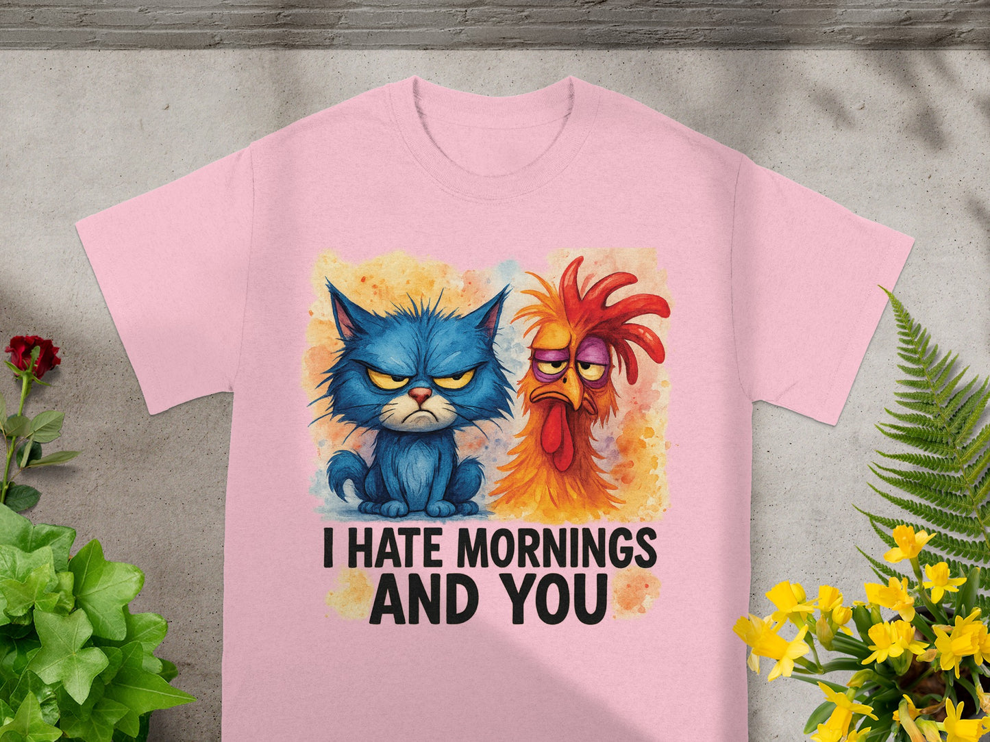 Pink t-shirt with grumpy blue cat and annoyed rooster graphics, saying "I Hate Mornings And You."