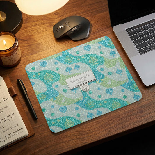 Kate Spade New York mousepad with spade pattern and metallic logo badge.