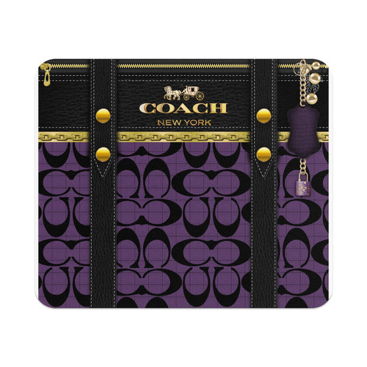Coach pattern with leather straps, gold hardware, and a padlock charm.