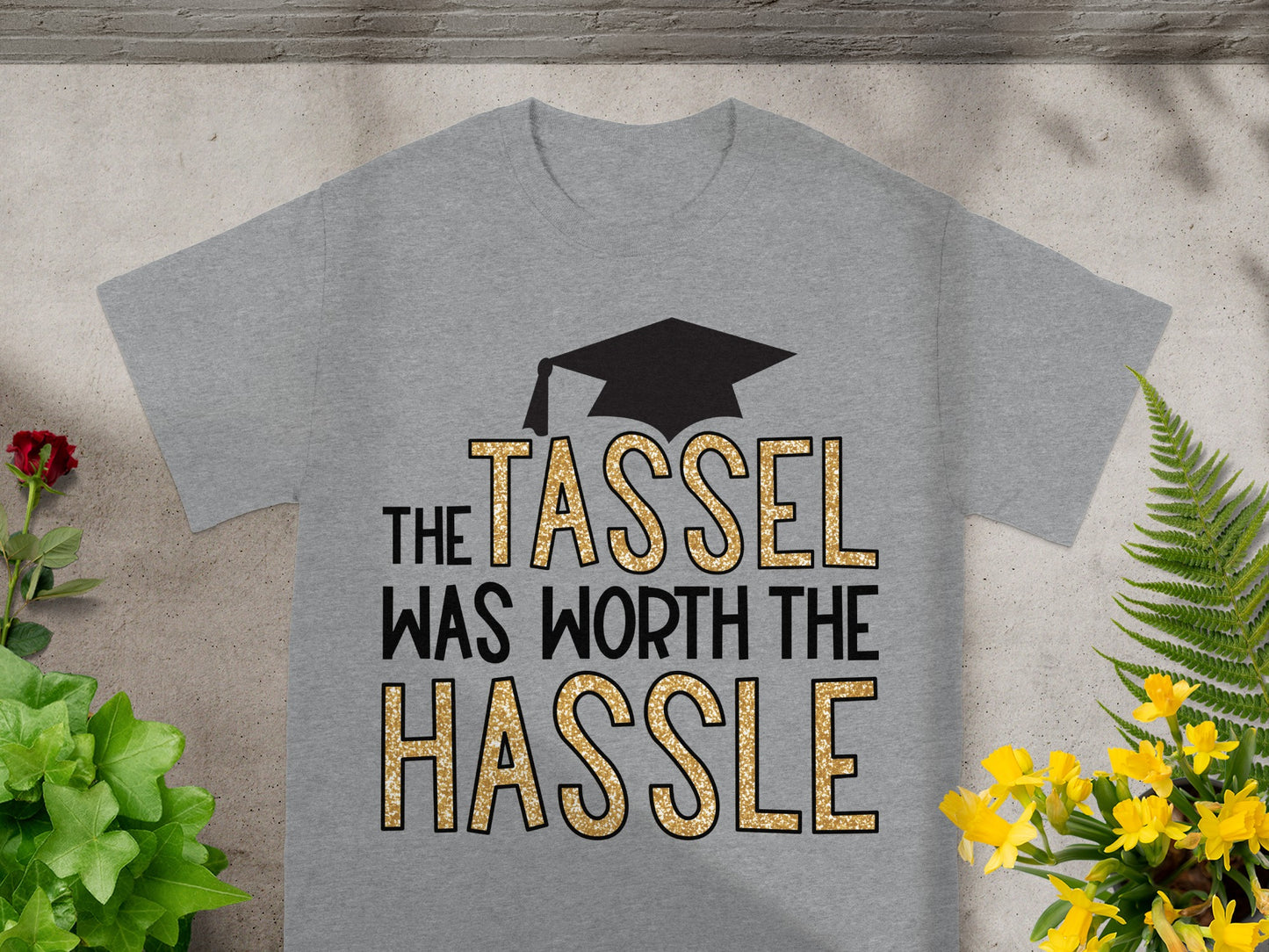 Grey t-shirt with graduation cap and text "The tassel was worth the hassle".