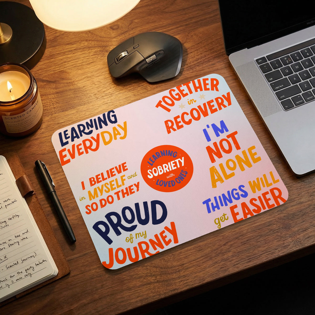 Mousepad with inspirational recovery phrases and colorful text.