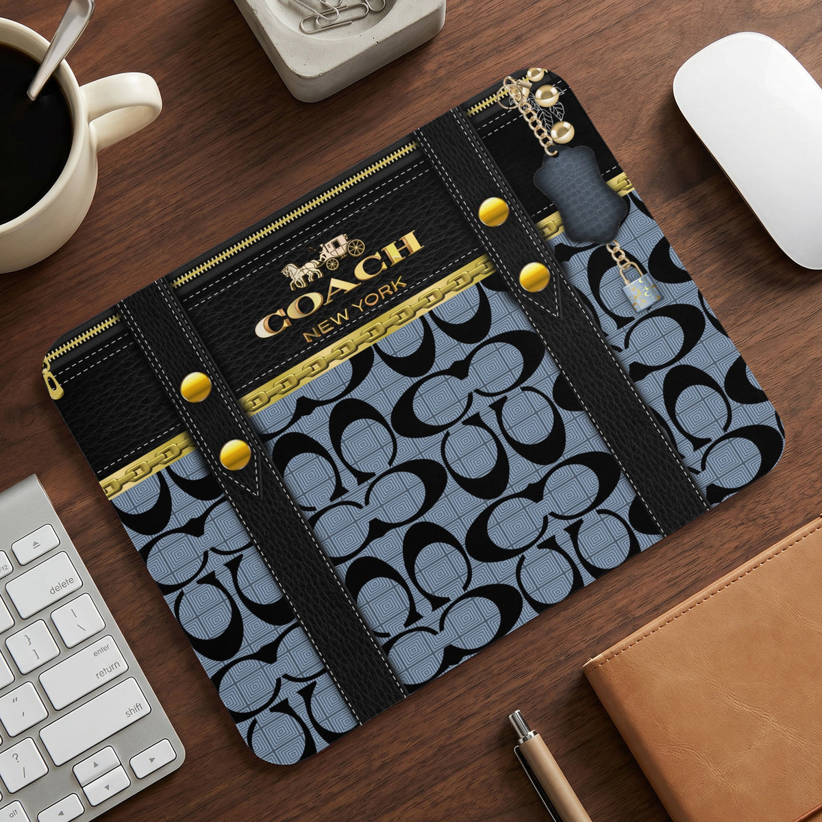 Coach New York mousepad with black leather accents and gold hardware.