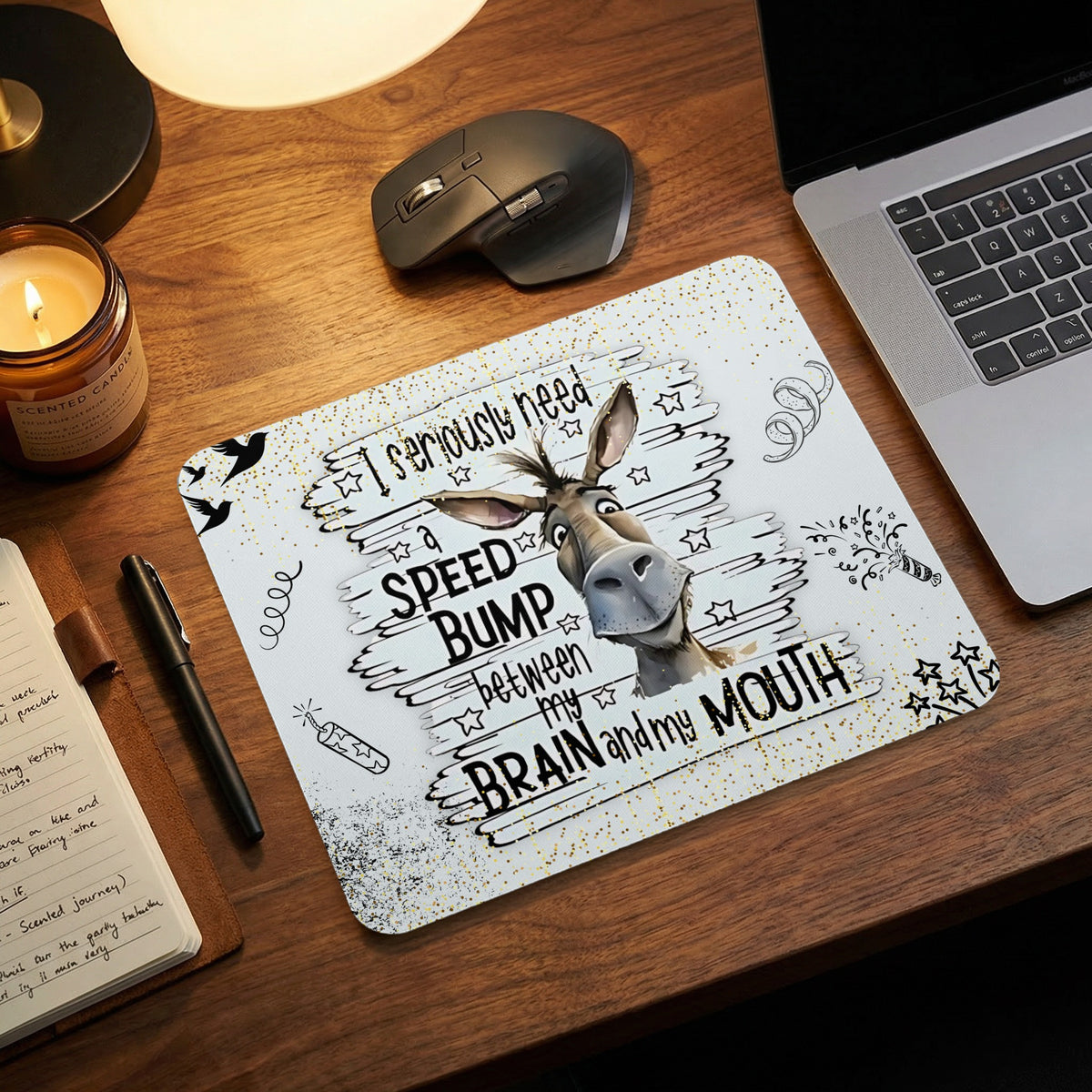 A mouse pad featuring a funny donkey illustration and the text I seriously need a speed bump between my brain and my mouth.