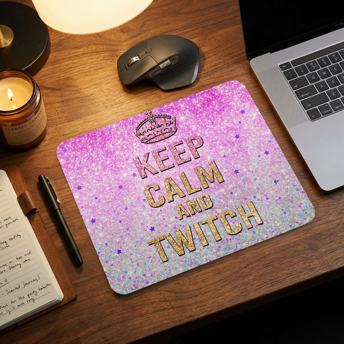 A pink and silver glitter mousepad featuring the text Keep Calm and Twitch on a wooden desk.