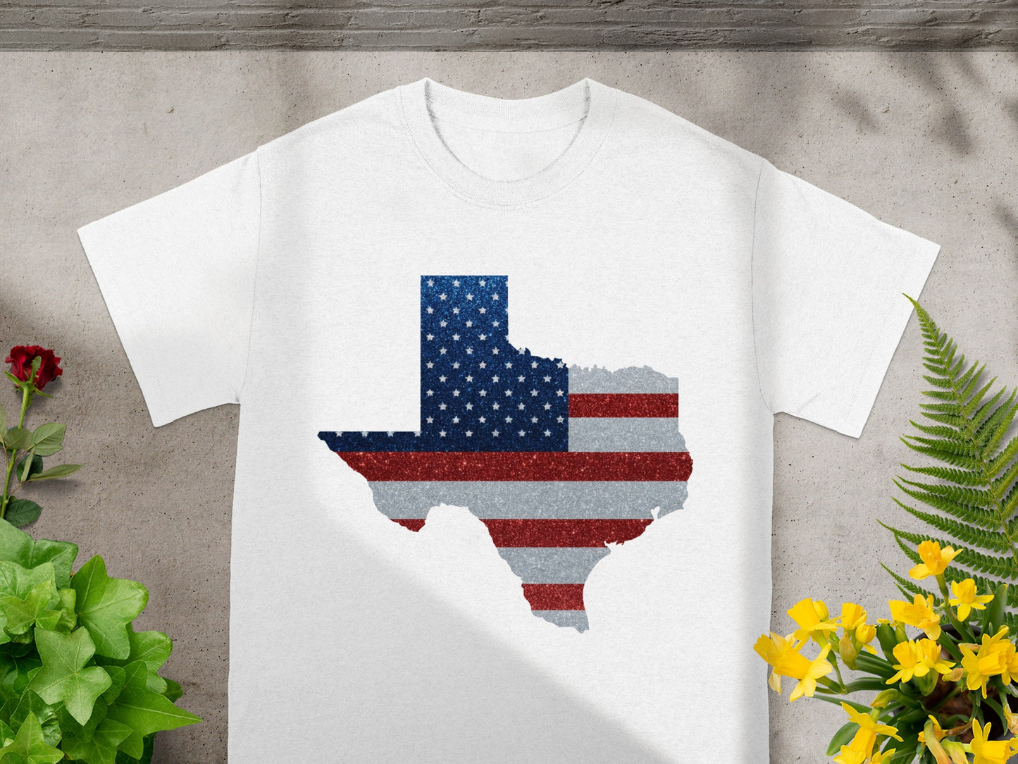 White t-shirt with Texas map outline in American flag glitter design.