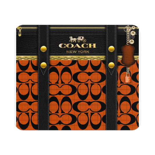 Coach New York black and orange signature pattern with keychain and lock.