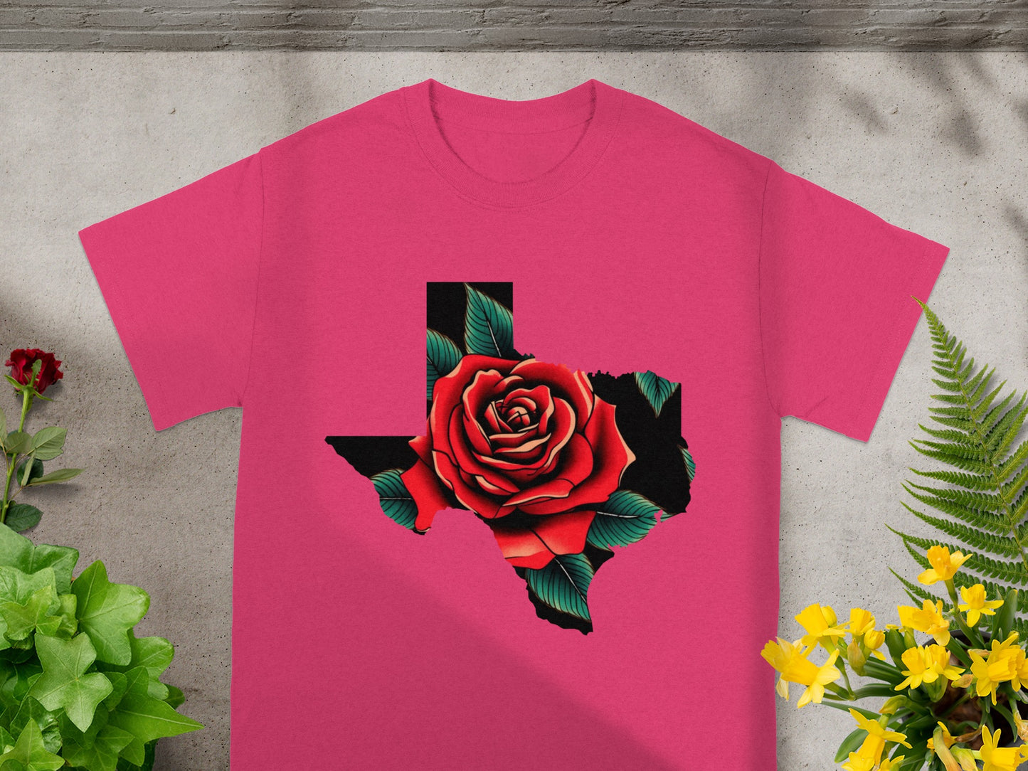 Pink t-shirt with a red rose inside a black Texas state outline.