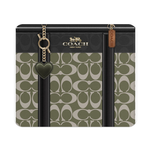 Coach wallet with green signature C pattern, gold hardware, and heart charm.