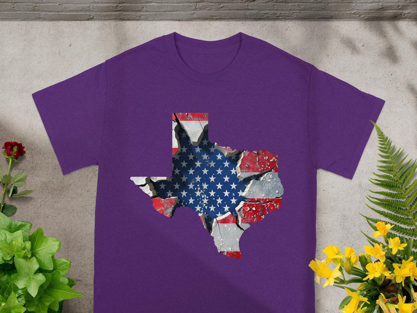 Purple t-shirt with Texas map outline filled with cracked American flag graphic.