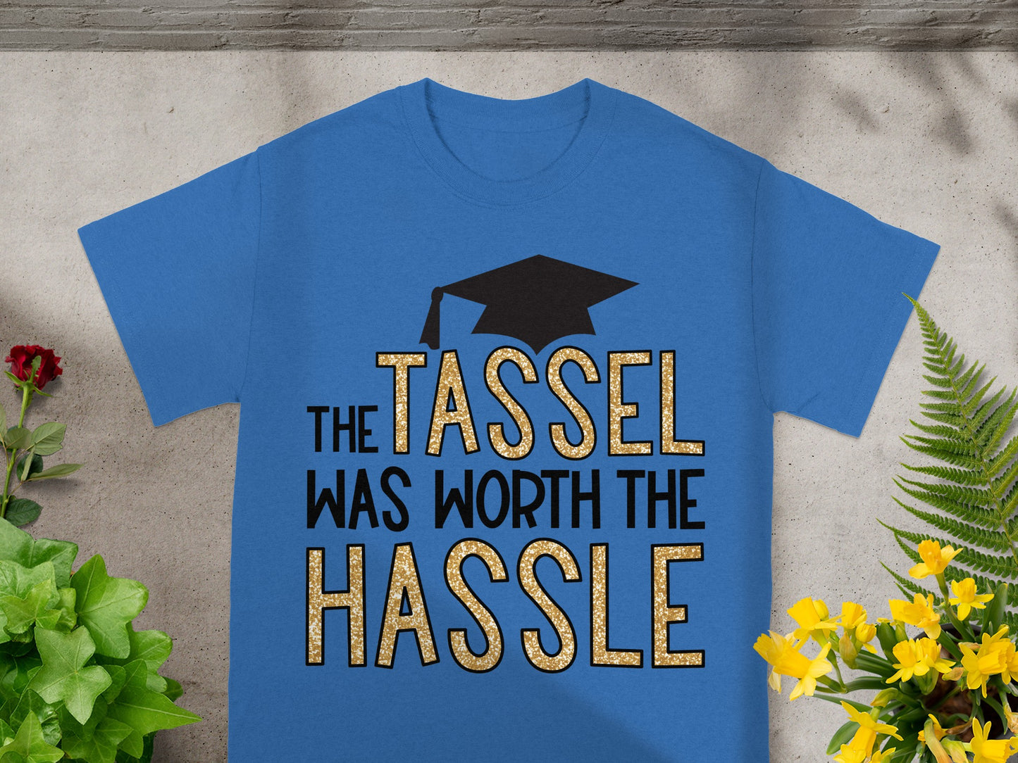 Blue t-shirt with gold glitter text that reads "The Tassel Was Worth the Hassle."