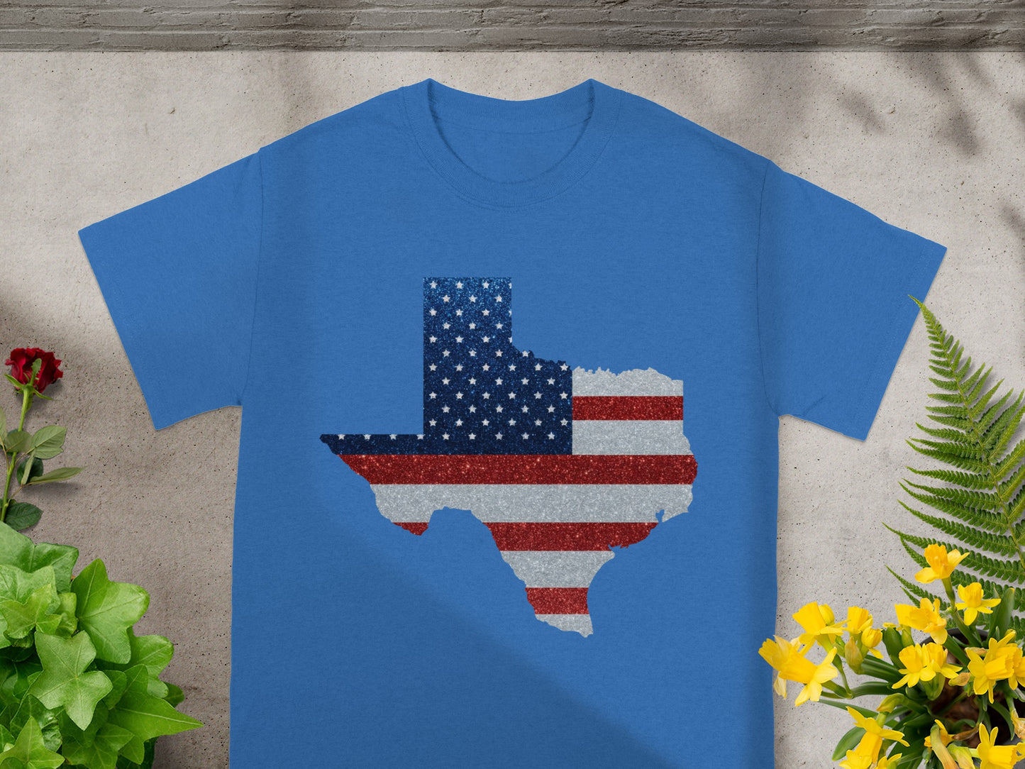Blue t-shirt with Texas shape filled with American flag glitter design.
