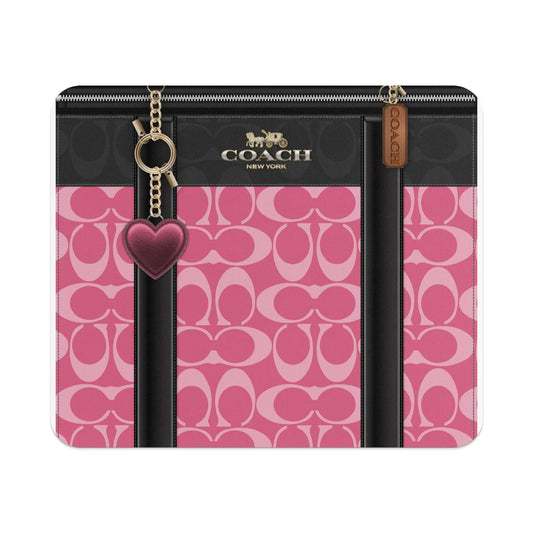 Coach wallet with pink monogram print and heart charm.