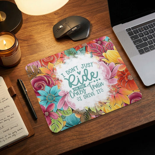 Mousepad with vibrant floral design and "I don't just Ride on the Crazy Train, I DRIVE IT." text.