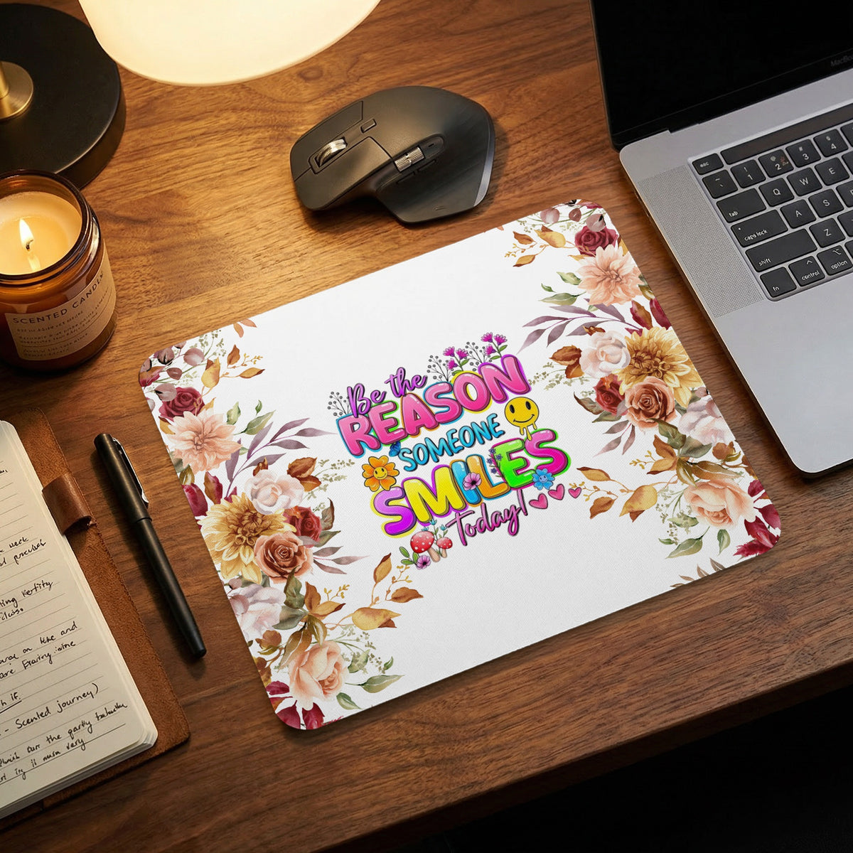 Mousepad with floral border and "Be the reason someone smiles today!" text.