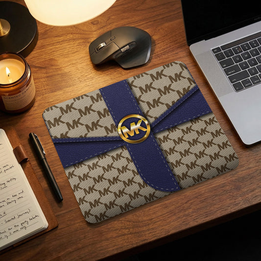 Mousepad with MK monogram pattern and blue ribbon detail.