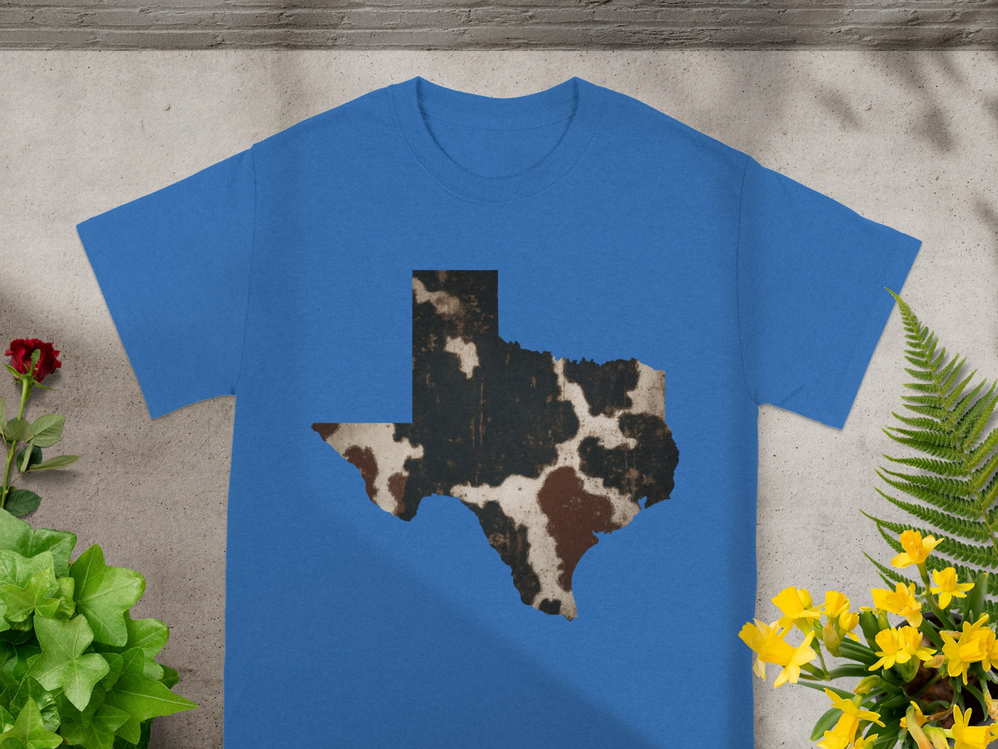 Blue t-shirt with a rustic Texas map outline graphic featuring a cowhide pattern.
