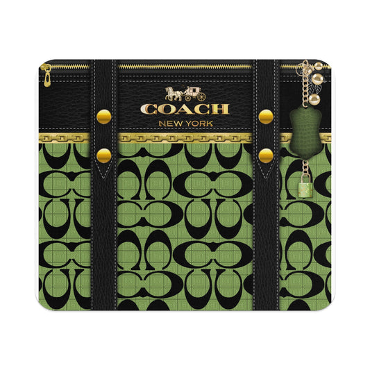 Coach New York black and green monogram pattern wallet with gold hardware and charm.
